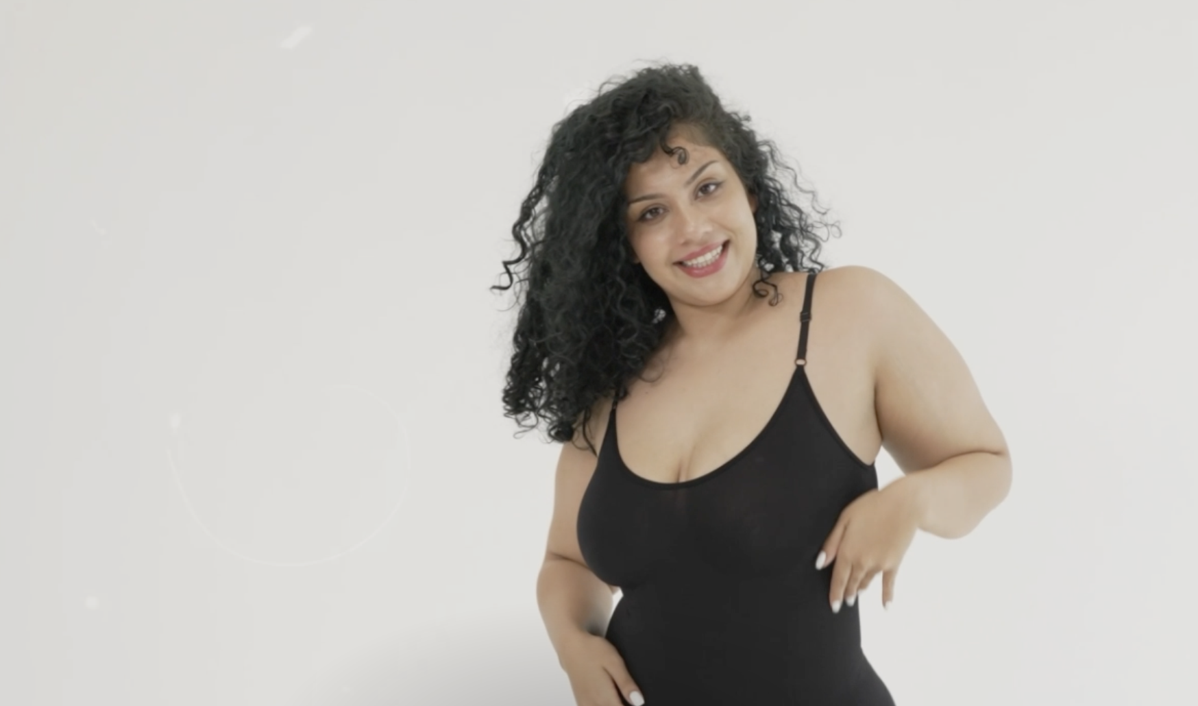 Lady wearing bodysuit in black - strappy and tight fititng