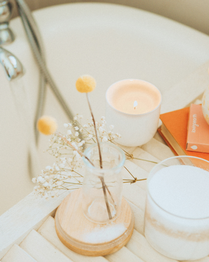 Self confence practices for a stronger you with a vase with flower and a candle